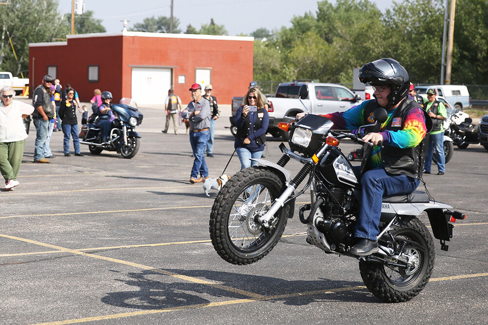 Dan Kluver, Gillette, raises his bike up and revs his engine